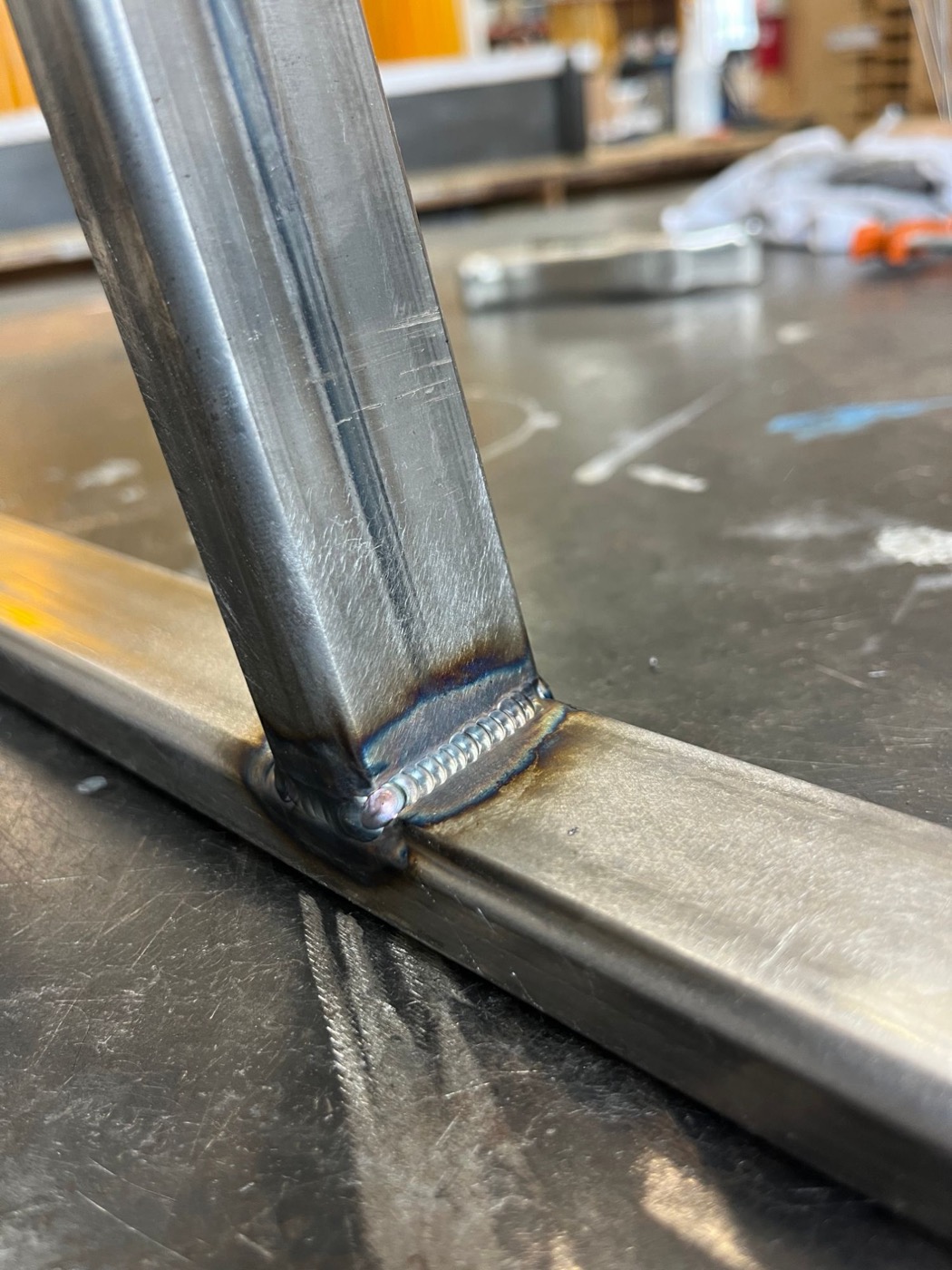 TIG weld joining two steel tubes with heat tint